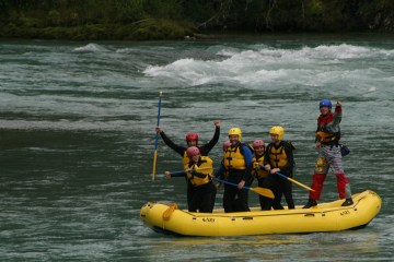 Standing up on a rafting boat